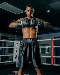 variant:black::TITLE Boxing Edge Boxing Trunks 2.0 guy hands together 