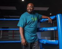 variant:Blue::TITLE Boxing Striped Wordmark Tee