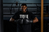 variant:lifestyle::TITLE Black Training Gloves 2.0 guy hitting gloves together