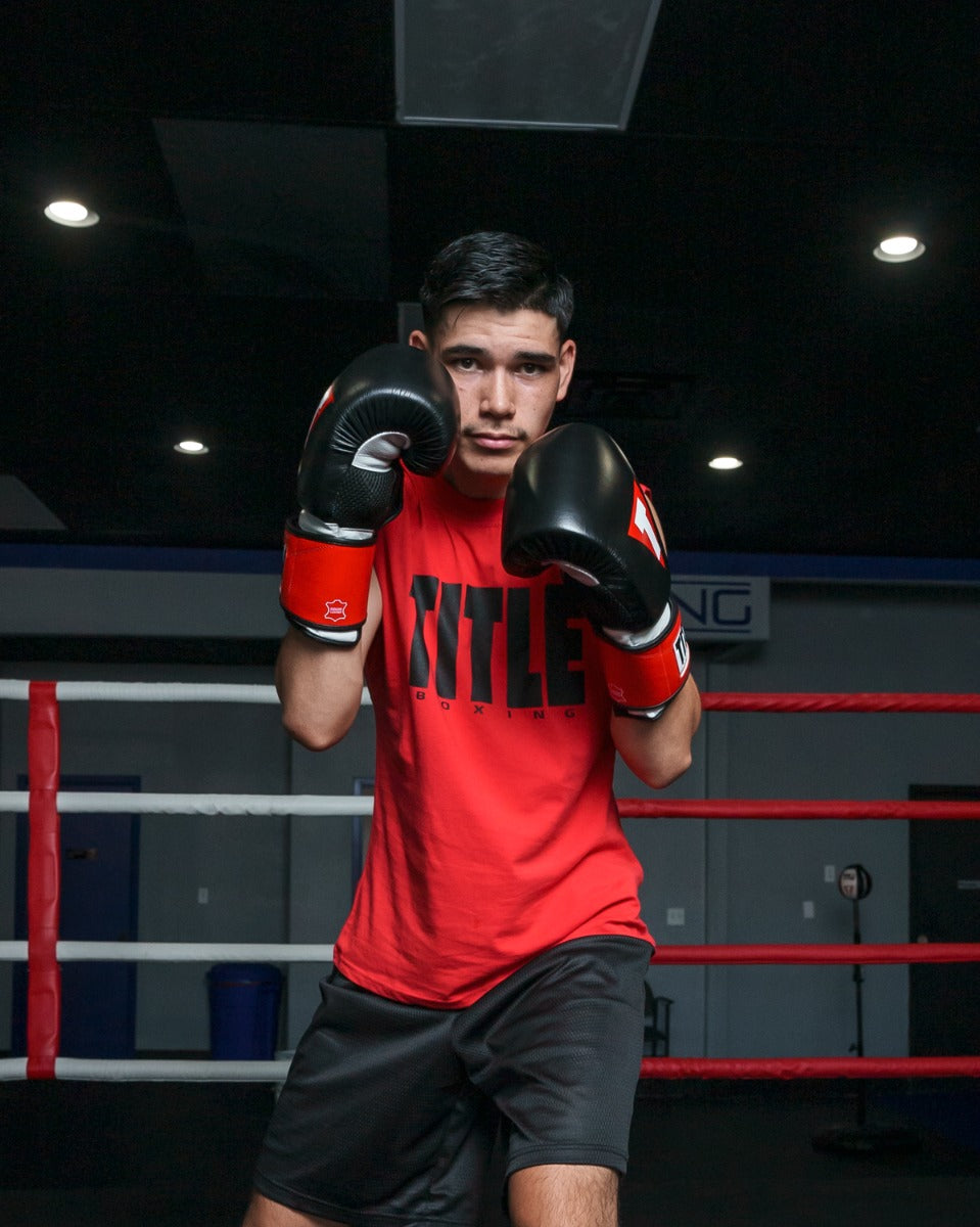 variant:Black/White/Red::TITLE Boxing Gel Weighted Boxing Gloves person posing with boxing gloves