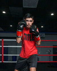 variant:Black/White/Red::TITLE Boxing Gel Weighted Boxing Gloves person posing with boxing gloves