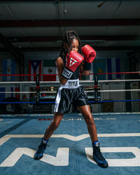 variant:black/white::TITLE Boxing Professional Women’s Satin Striped Boxing Trunks boxing pose