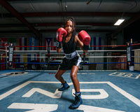 variant:black/white::TITLE Boxing Professional Women’s Satin Striped Boxing Trunks boxing stance