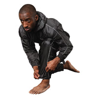 variant:lifestyle::TITLE Boxing Sauna Suit With Hood guy posing wearing sauna suit showing detail on legs