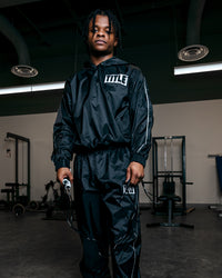 variant:lifestyle::TITLE Boxing Sauna Suit With Hood guy posing wearing sauna suit and holding jump rope