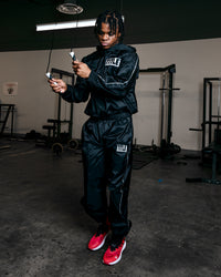 variant:lifestyle::TITLE Boxing Sauna Suit With Hood guy wearing sauna suit jumping rope