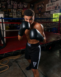 variant:Black::TITLE Boxing Vegan Fitness Bag Gloves man holding up gloves