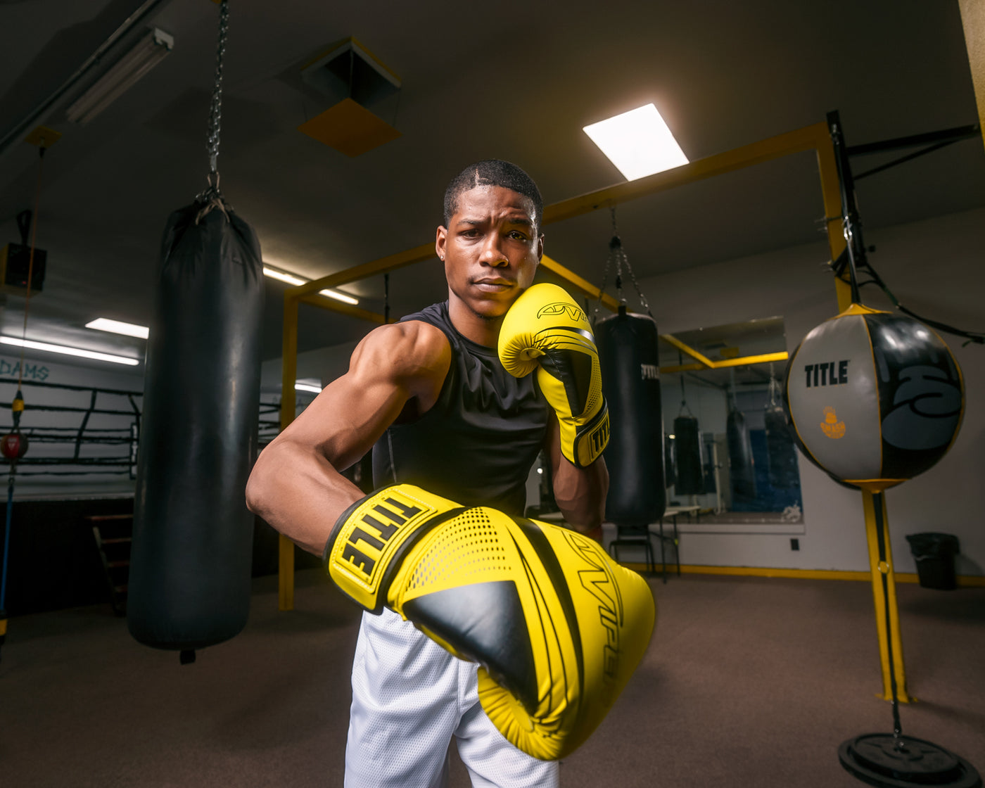 variant:Black/Neon Yellow::Viper by TITLE Boxing Strike Select Bag Gloves 2.0 man posing in gloves