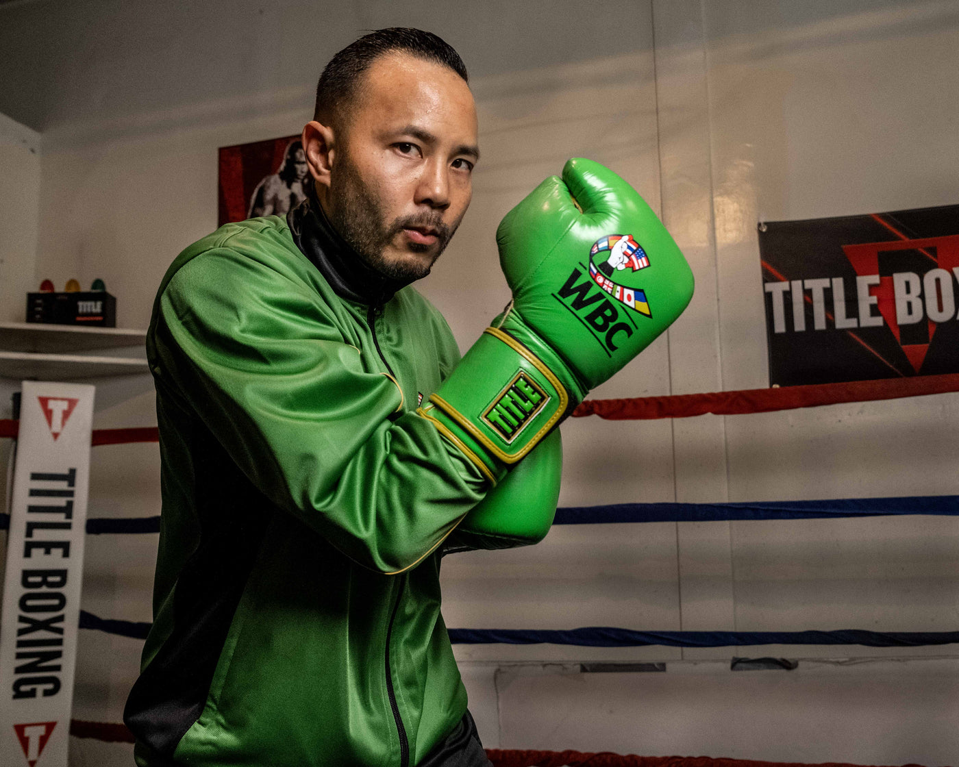 variant:Green/Black::WBC by TITLE Boxing Bag Gloves man wearing gloves posing