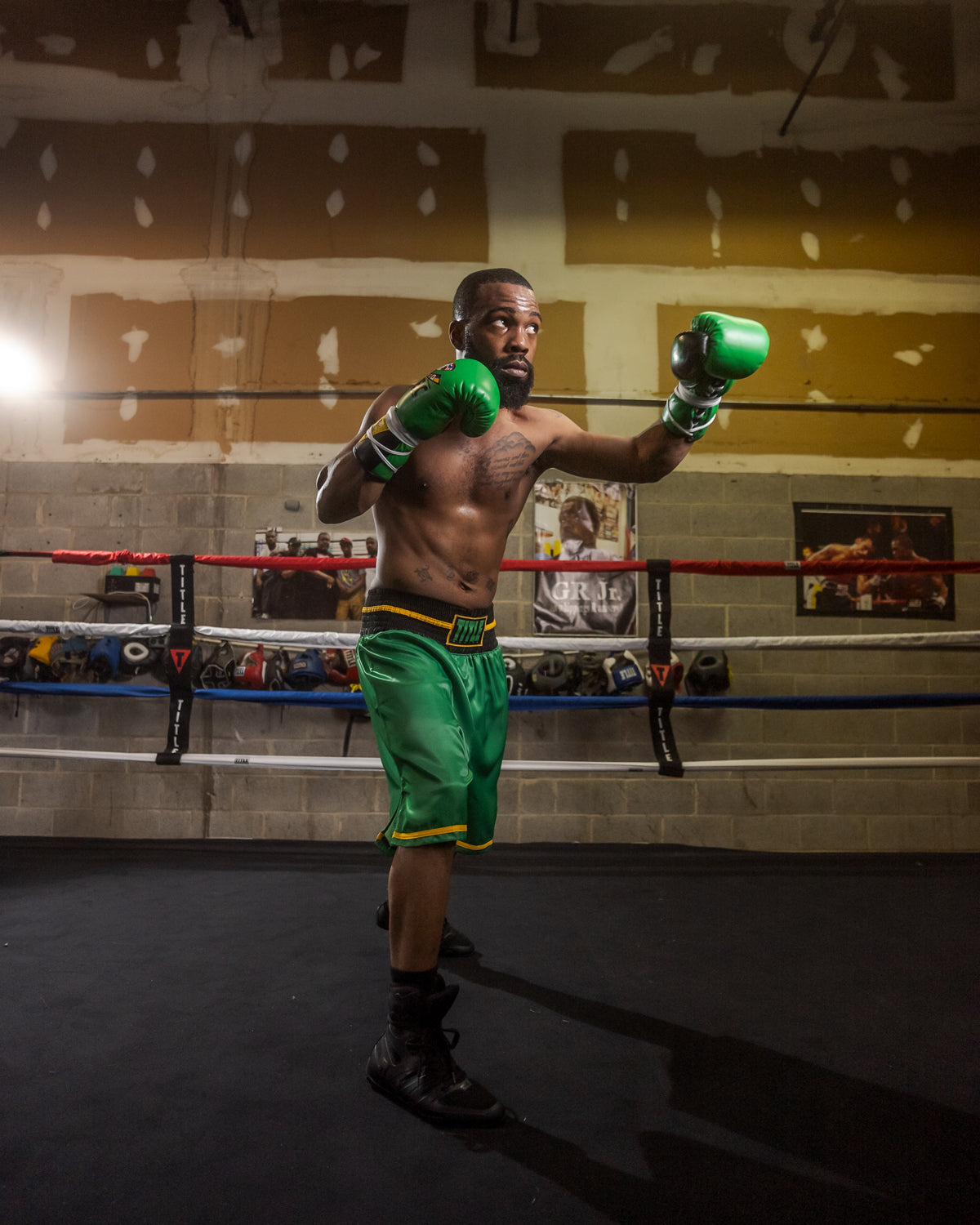 variant:Green/Black::WBC by TITLE Boxing Professional Boxing Trunks left jab man in ring