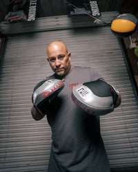 variant:lifestyle::TITLE Boxing Aerovent Anarchy Punch Mitts main view coach with mitts on 