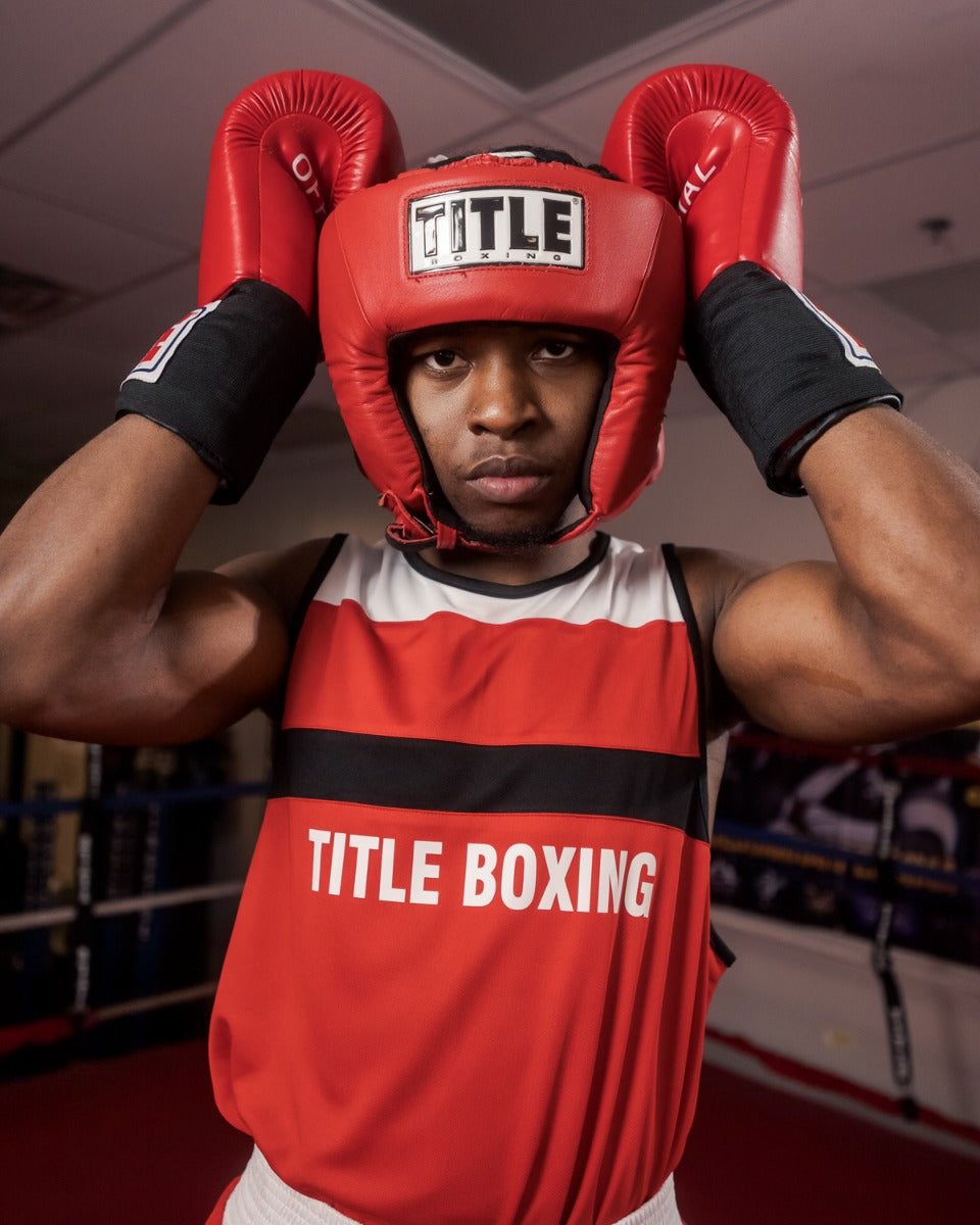 variant:red::TITLE Boxing USA Boxing Competition Headgear - Open Face guy hands on headgear on head