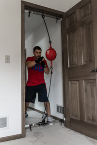 variant:lifestyle::TITLE Boxing Adjustable Doorway Hanger in use
