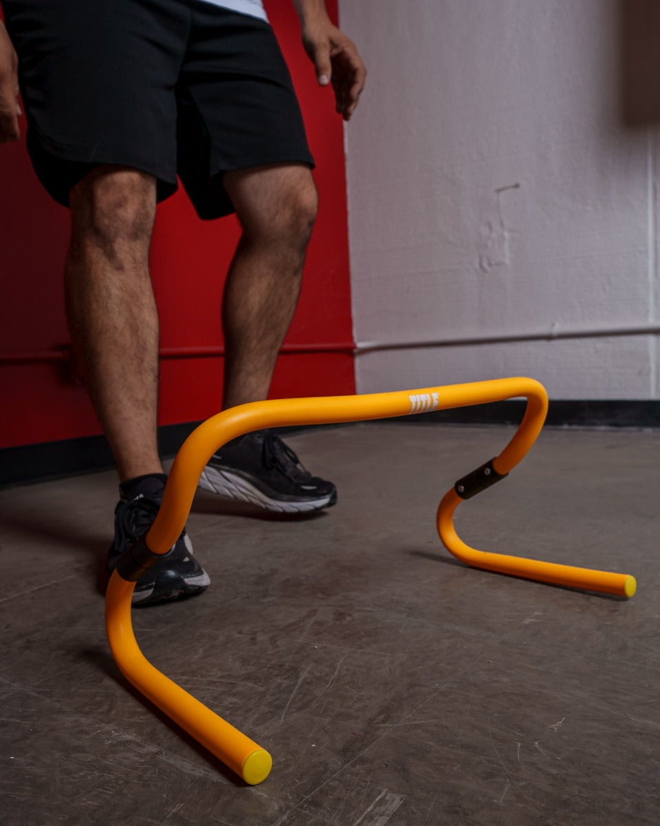 variant:lifestyle::TITLE Boxing Adjustable Speed & Agility Hurdle 2.0 on the floor of a boxing gym