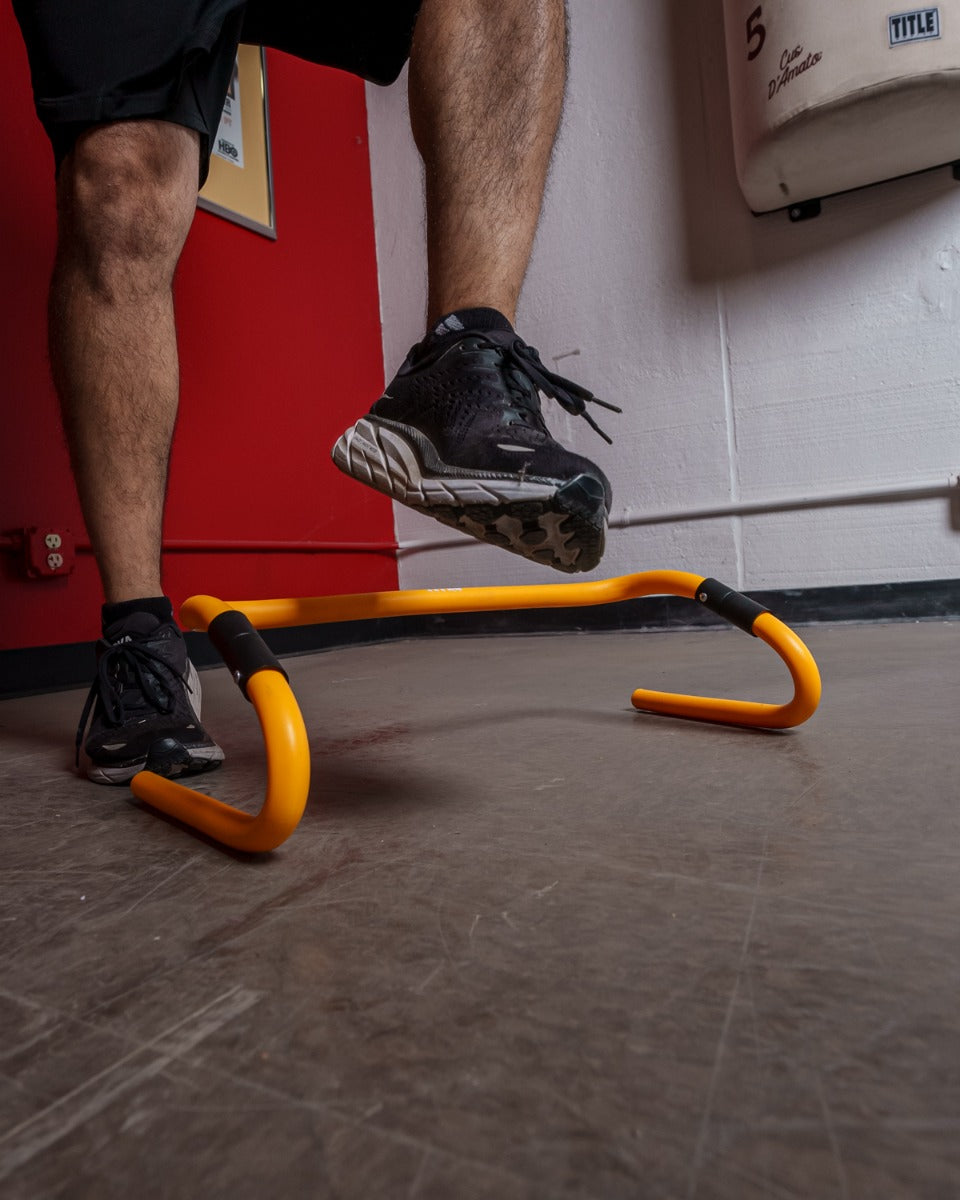 variant:lifestyle::TITLE Boxing Adjustable Speed & Agility Hurdle 2.0 with a boxer using it
