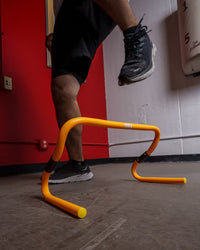 variant:lifestyle::TITLE Boxing Adjustable Speed & Agility Hurdle 2.0 being used by a boxer