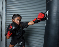 variant:black/red::TITLE Boxing All Heart Bag Gloves 2.0 girl jabbing bag