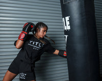 variant:black/red::TITLE Boxing All Heart Bag Gloves 2.0 girl hitting bag