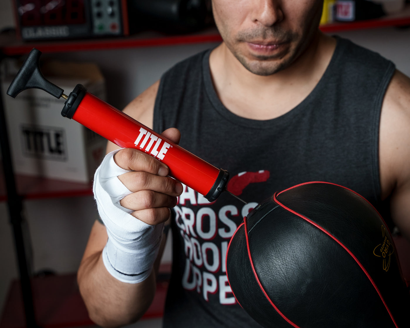 variant:lifestyle::TITLE Boxing Replacement Air Needles 2.0 being used to inflate a speed bag