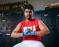 variant:lifestyle::TITLE Boxing Advanced Semi-Elastic Assorted Hand Wraps (10 Pair) blue color on a boxer