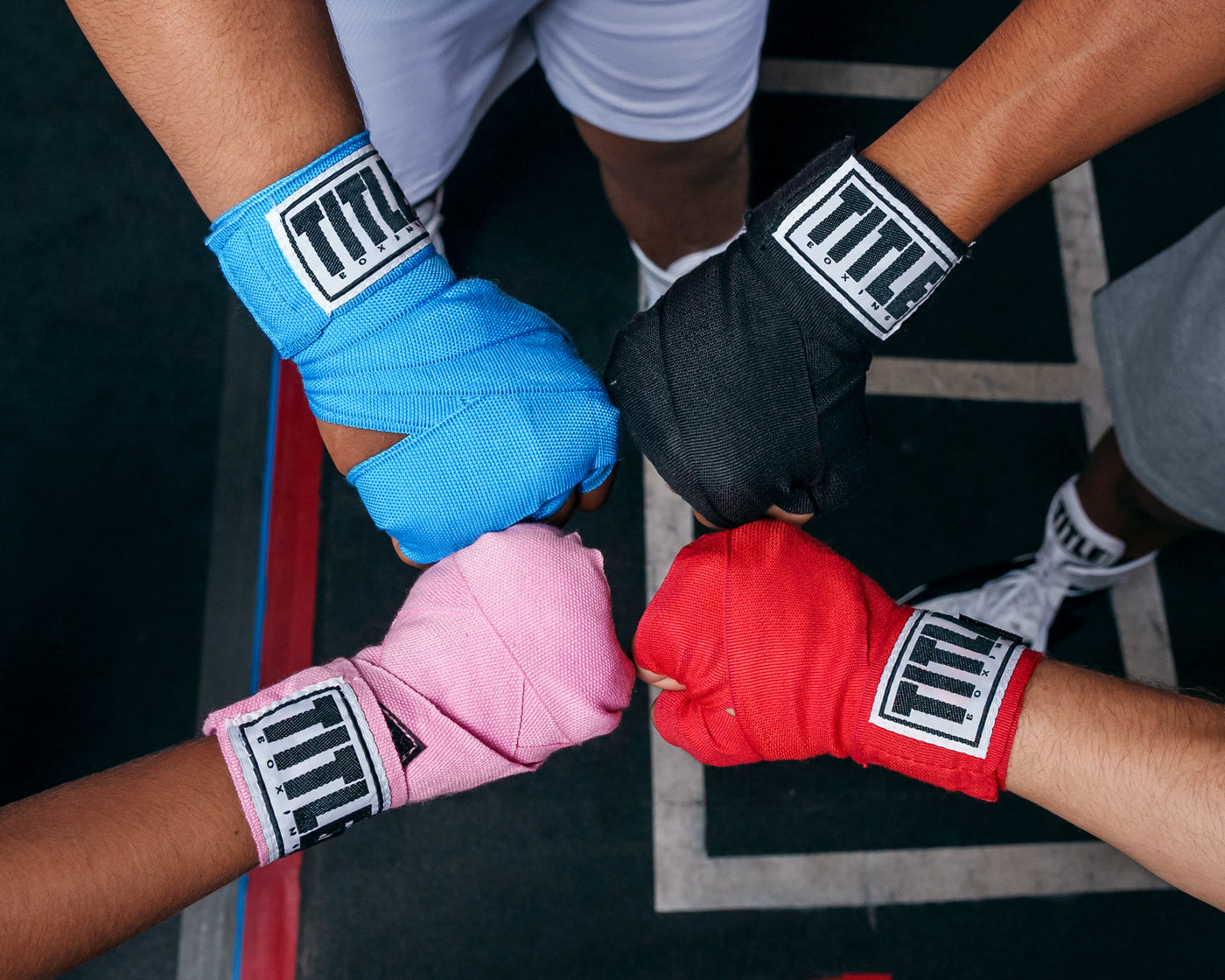 variant:lifestyle::TITLE Boxing Advanced Semi-Elastic Assorted Hand Wraps (10 Pair) various colors on boxer's hands