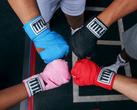 variant:lifestyle::TITLE Boxing Advanced Semi-Elastic Assorted Hand Wraps (10 Pair) various colors on boxer's hands