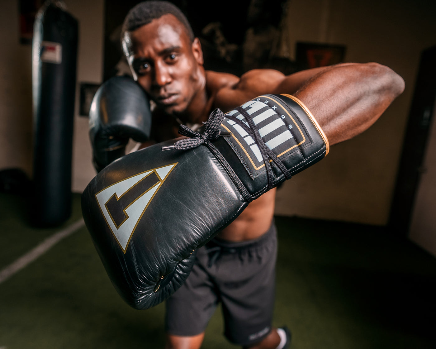 variant:black/white::TITLE Boxeo Mexican Leather Lace Training Gloves Quatro guy throwing left hook