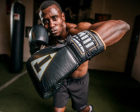 variant:black/white::TITLE Boxeo Mexican Leather Lace Training Gloves Quatro guy throwing left hook