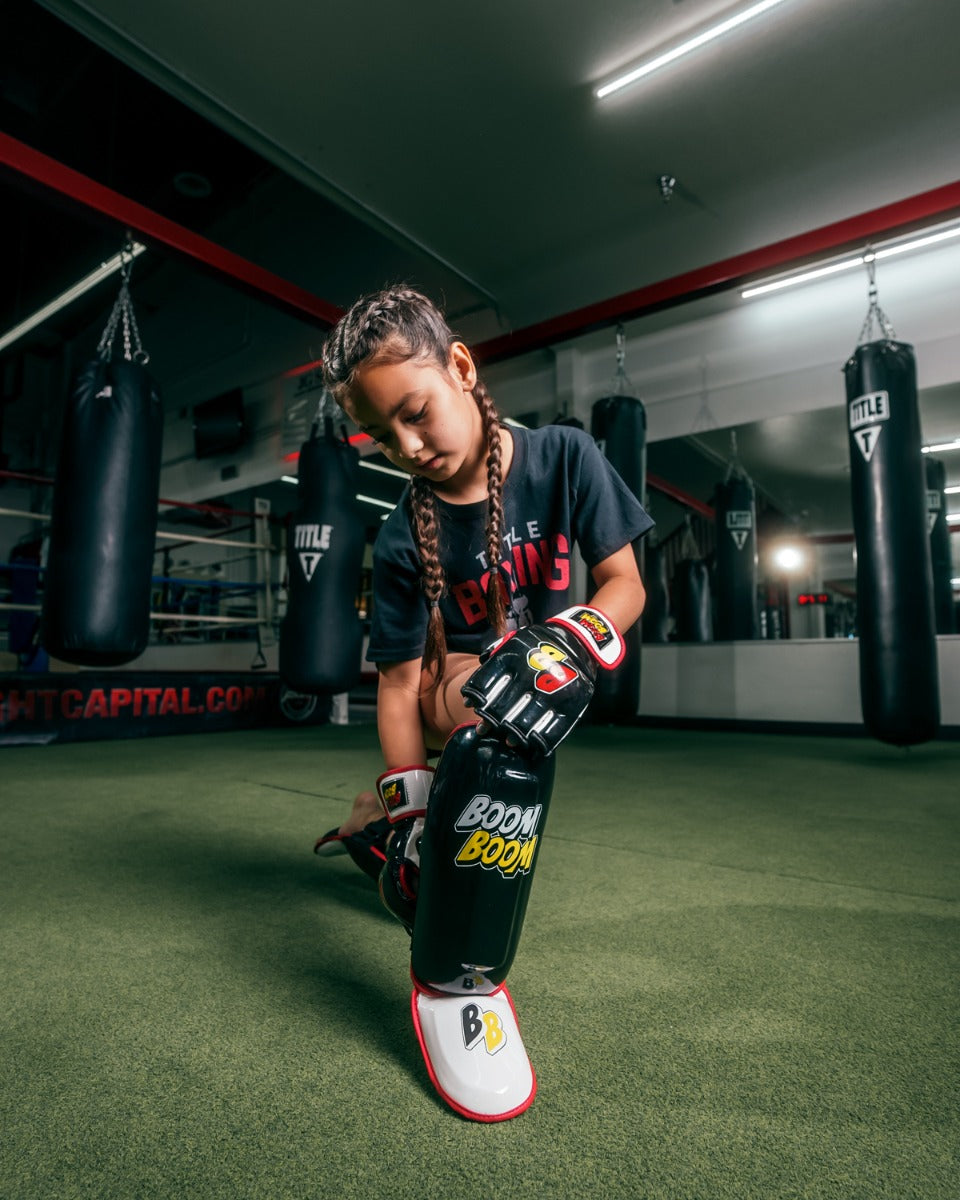 variant:Lifestyle::BOOM BOOM Boxing Bomber Youth Shin Guards girl showing shin guards