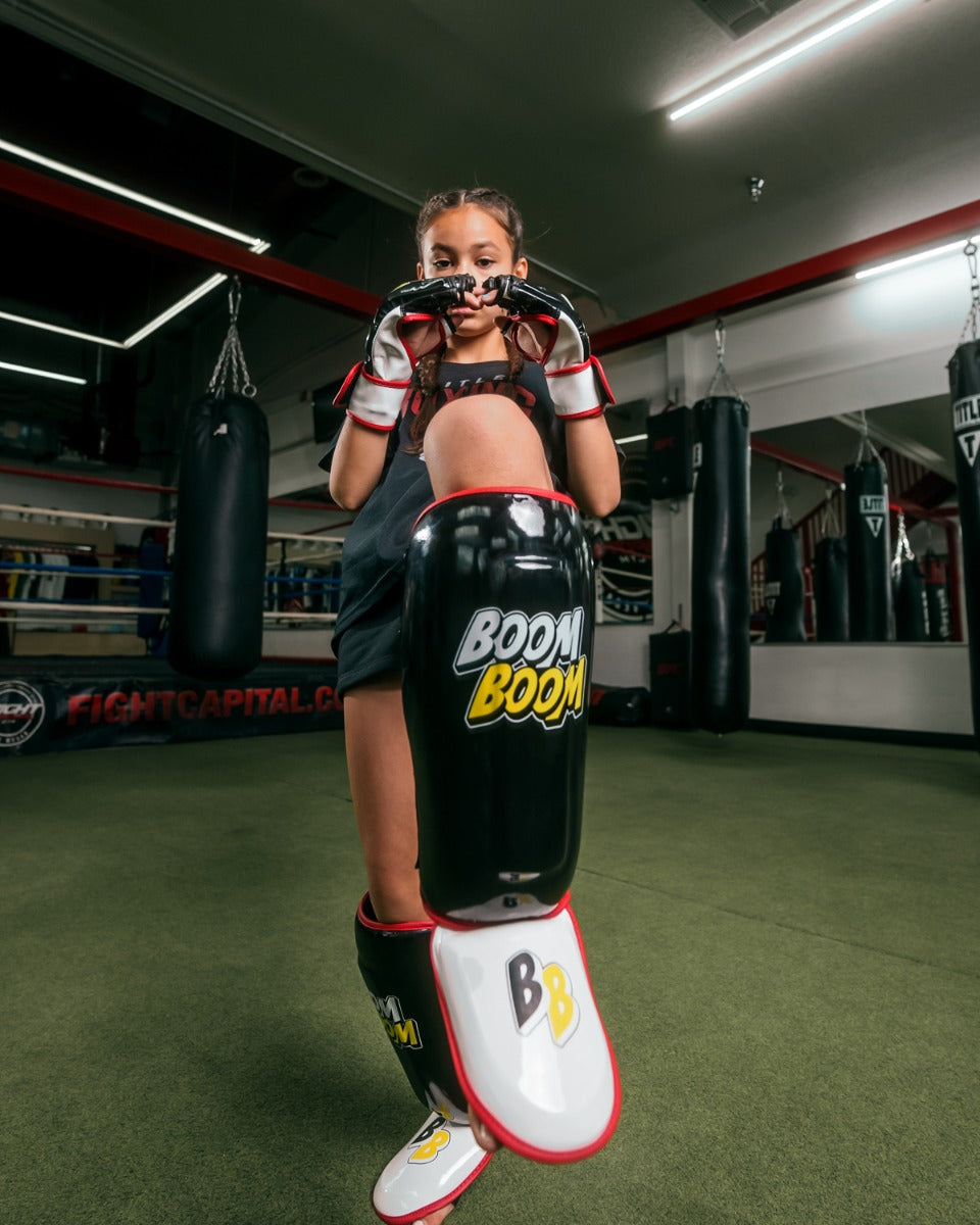 variant:Lifestyle::BOOM BOOM Boxing Bomber Youth Shin Guards girl posing