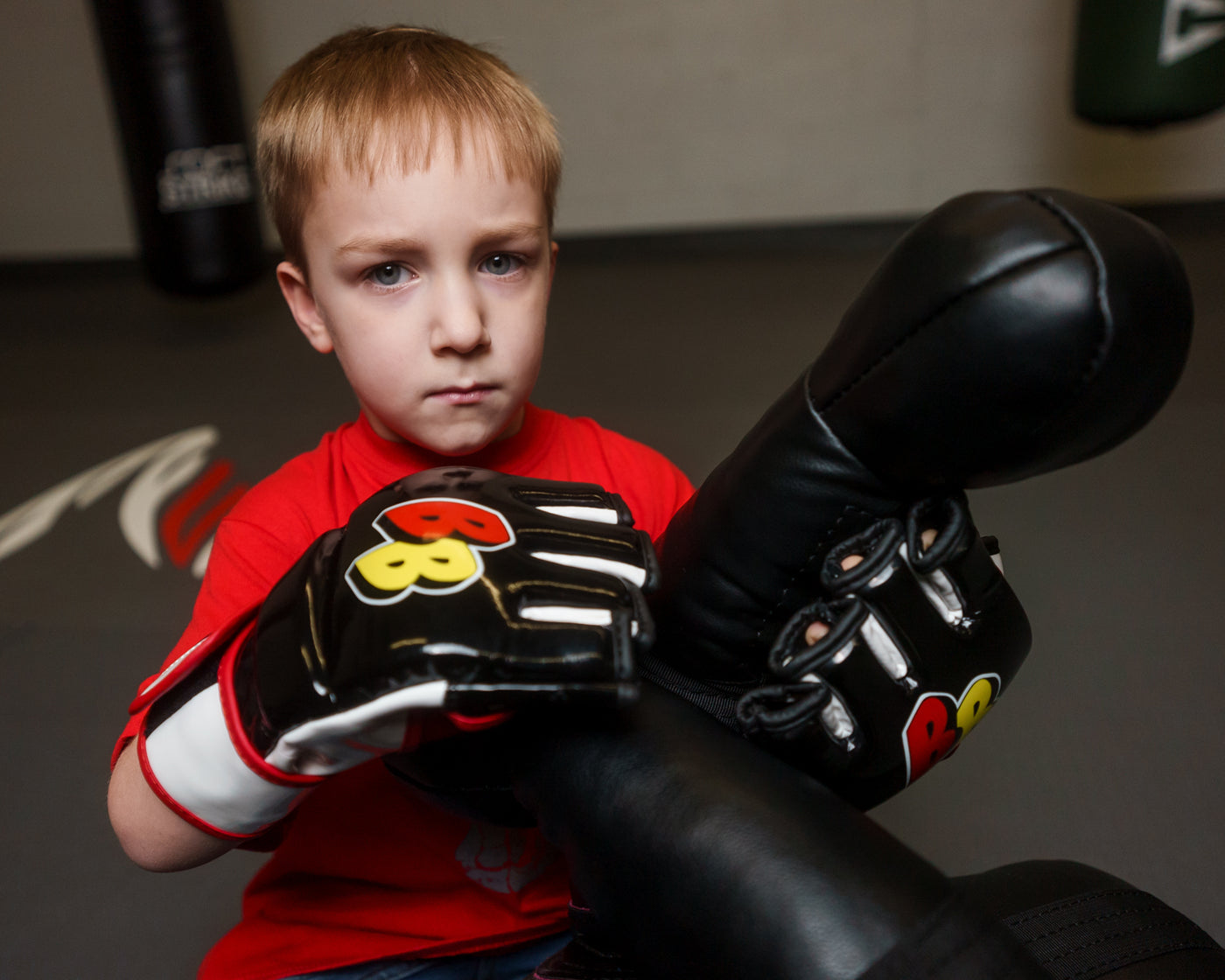 variant:black/white/red::BOOM BOOM Boxing Bomber Youth MMA Glove kid putting on gloves