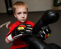 variant:black/white/red::BOOM BOOM Boxing Bomber Youth MMA Glove kid putting on gloves
