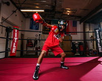 variant:lifestyle:: BOOM BOOM Boxing Striker Youth Boxing Set 2 kid posing with arms up in set