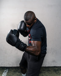 variant:lifestyle::TITLE Black Lace Sparring Gloves 2.0 guy posing boxing stanceview