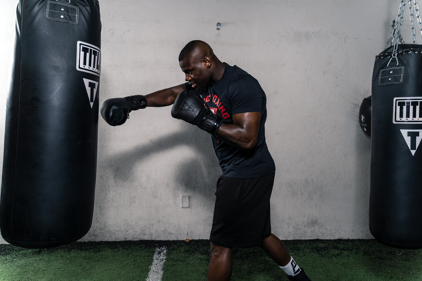 variant:lifestyle::TITLE Black Lace Sparring Gloves 2.0 guy punching bag