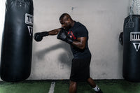 variant:lifestyle::TITLE Black Lace Sparring Gloves 2.0 guy punching bag