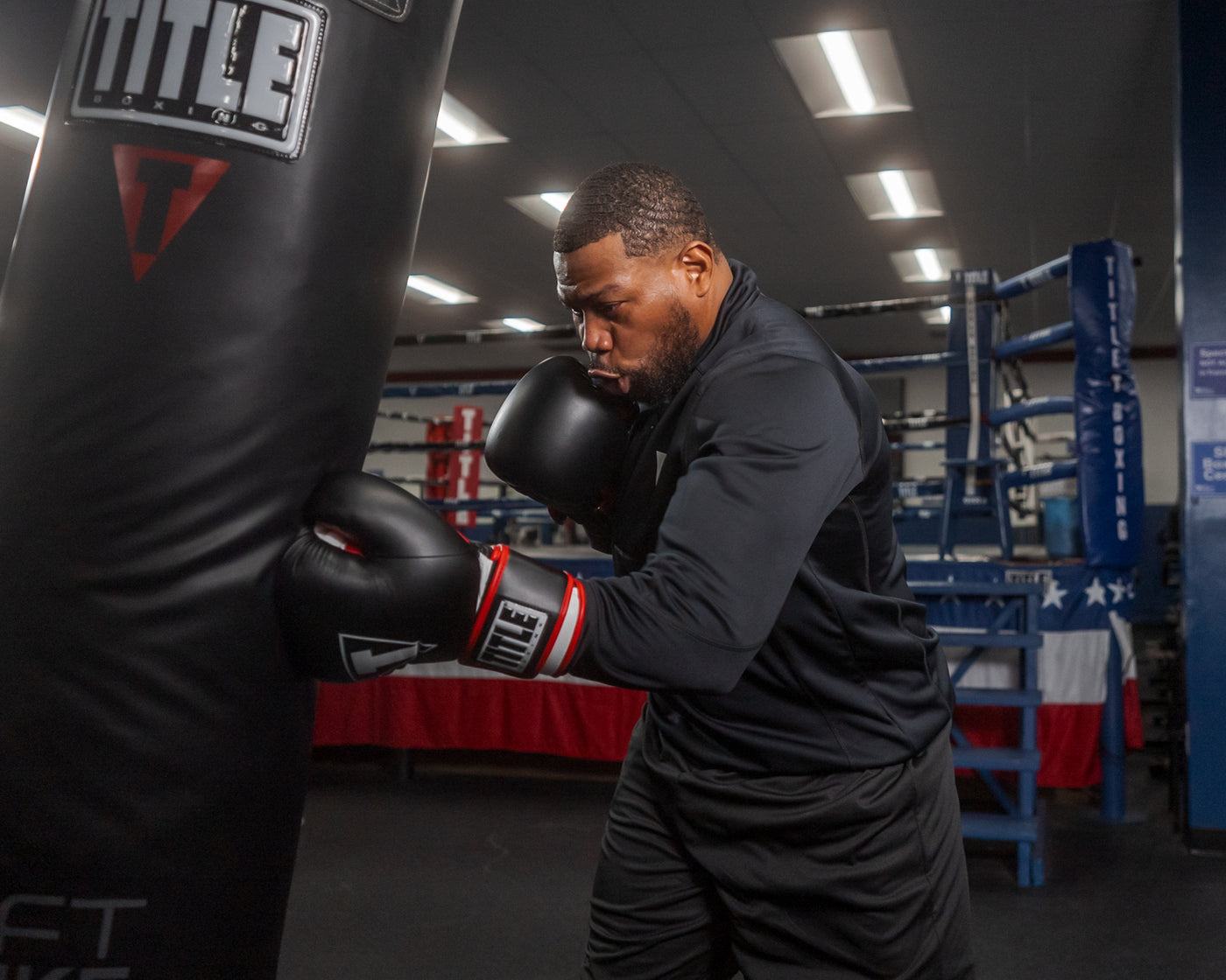 variant:lifestyle::TITLE Boxing Leather Big League Bag Gloves guy hitting a bag