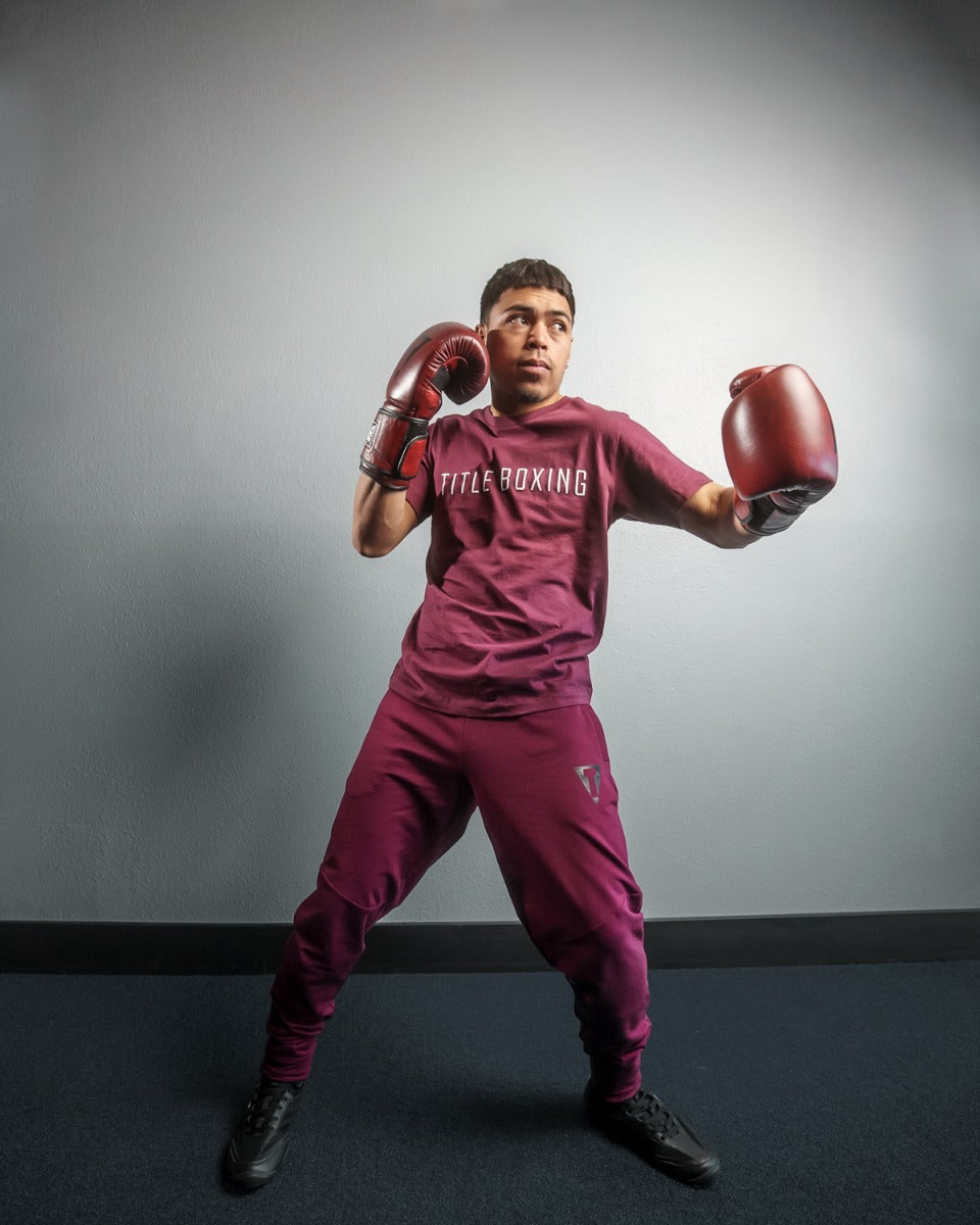 variant:lifestyle::TITLE Boxing Blood Red Leather Bag Gloves guy throwing a left jab