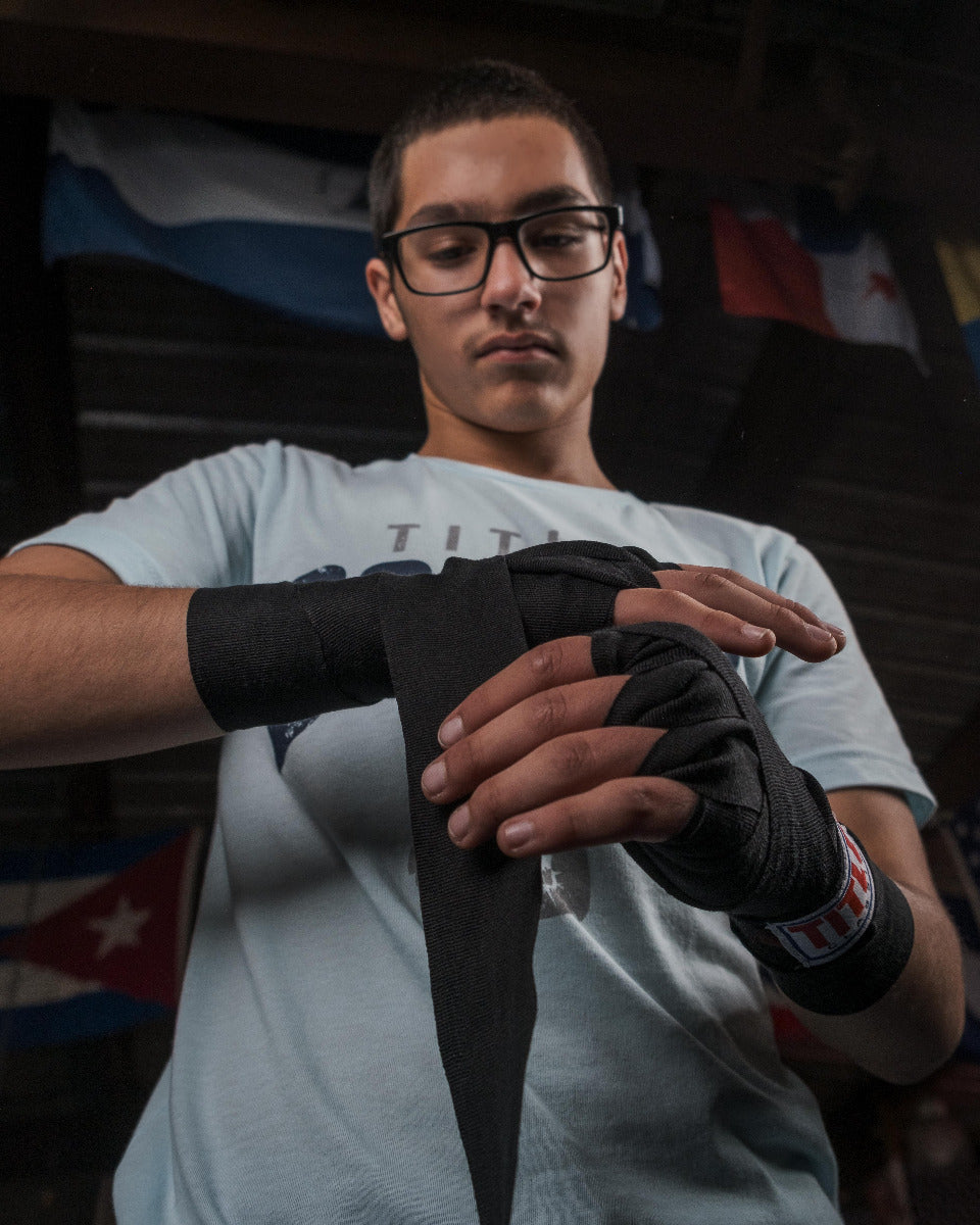 variant:lifestyle::TITLE Classic Advanced 108" Hand Wraps V2 putting on wraps