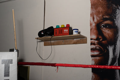 variant:lifestyle::TITLE Classic Pro Gym Timer on a shelf in a boxing gym