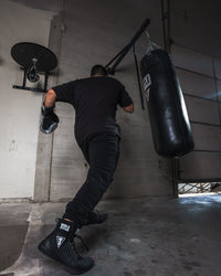 variant:lifestyle::TITLE Classic Heavy Bag Wall Hanger 2.0 in use with a heavy bag
