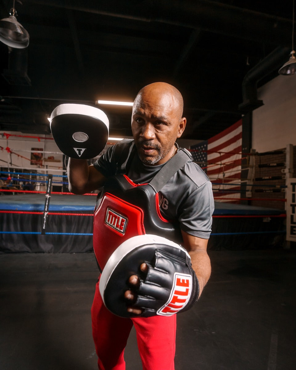 variant:lifestyle::TITLE Classic Command Body Protector 2.0 boxing stance with mitts