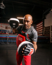 variant:lifestyle::TITLE Classic Command Body Protector 2.0 boxing stance with mitts