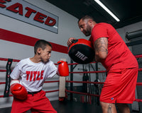 variant:lifestyle::TITLE Classic Round Punch Shield V2 kid punching