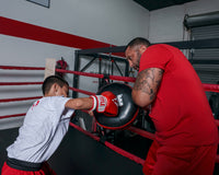 variant:lifestyle::TITLE Classic Round Punch Shield V2 coach and kid