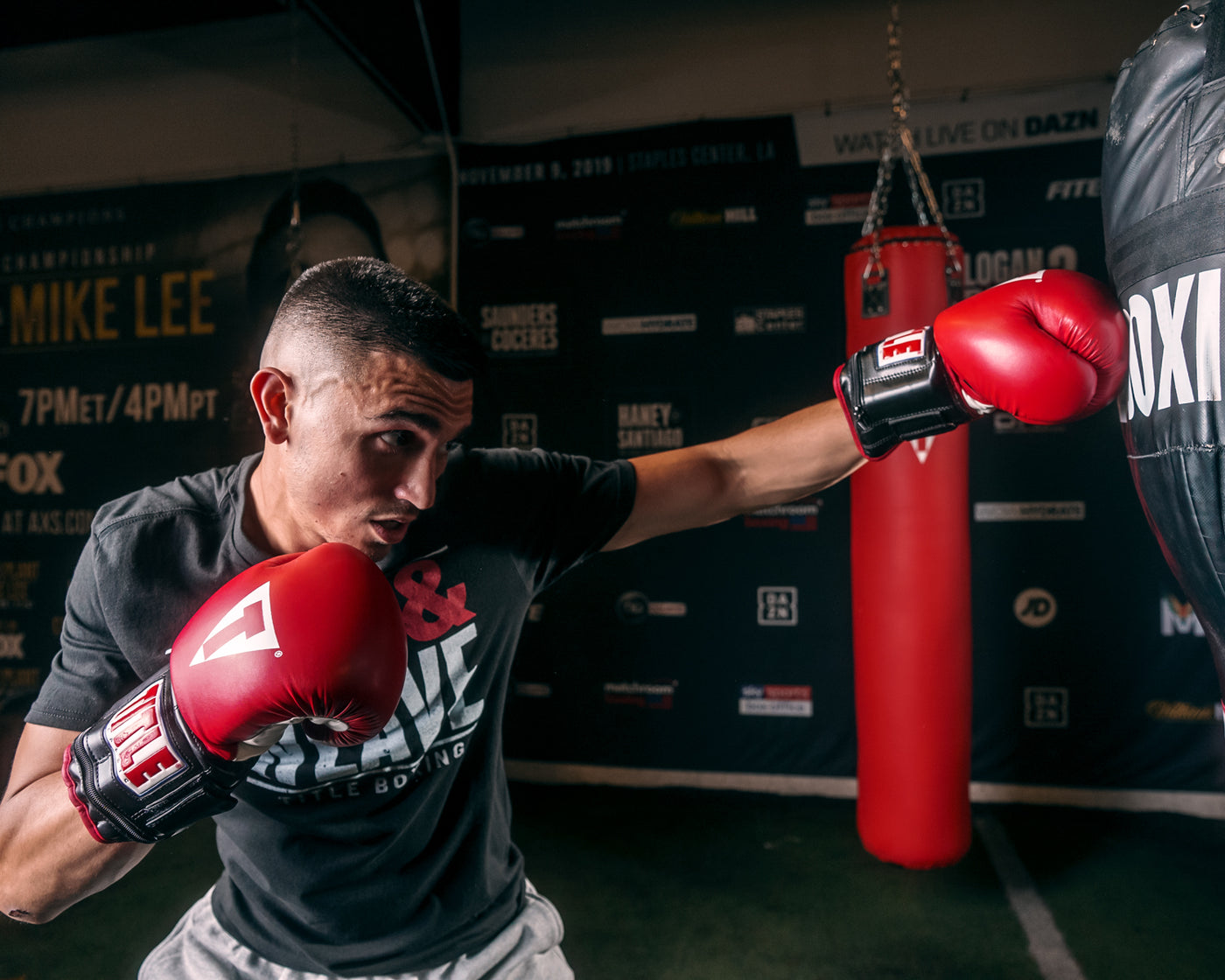 variant:lifestyle::TITLE Classic Power Weight Bag Gloves guy hitting left jab