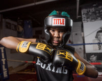 variant:lifestyle::TITLE Classic Hi-Performance Headgear 2.0 kid wearing yellow ALI gloves