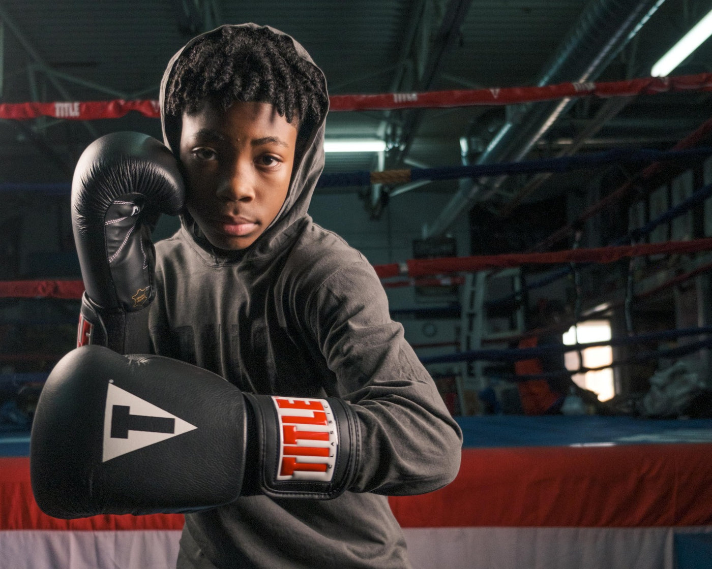 variant:black::TITLE Classic Leather Elastic Training Gloves kid posing 
