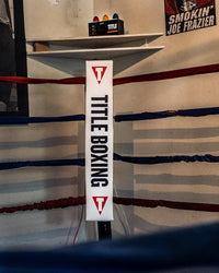 variant:lifestyle::TITLE Boxing Deluxe Gym Timer next to a boxing ring