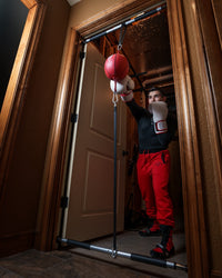 variant:lifestyle::TITLE Boxing Doorway Double End Bag Hanger in use in a doorway